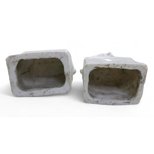 105 - A pair of Chinese blanc de chine Fo dogs, 7 by 5 by 13cm high.