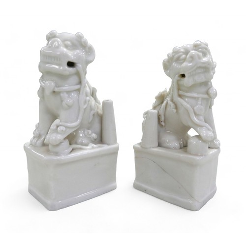 105 - A pair of Chinese blanc de chine Fo dogs, 7 by 5 by 13cm high.