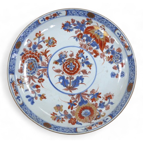 106 - An 18th century Chinese Imari dish, painted and gilt with lotus and other flowering plants in panell... 