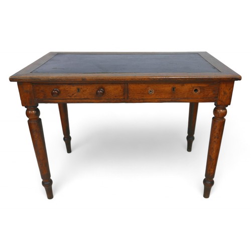 289 - A late Victorian oak writing table by Holt & sons, with an inset top and two frieze drawers on turne... 