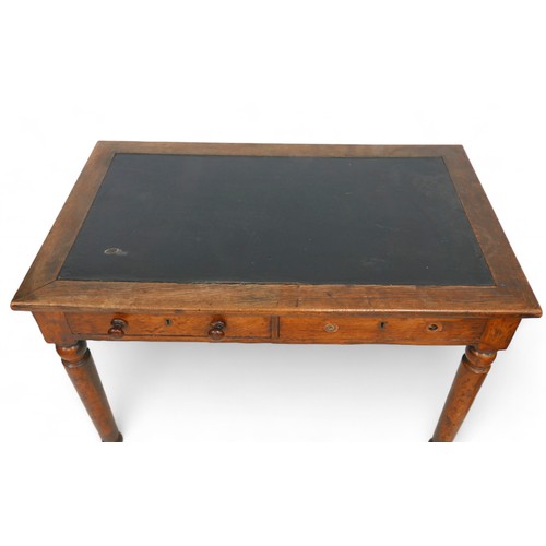 289 - A late Victorian oak writing table by Holt & sons, with an inset top and two frieze drawers on turne... 