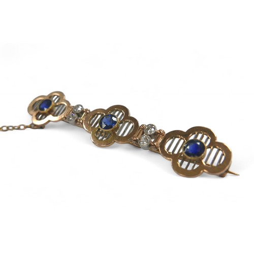 77 - A diamond and sapphire yellow metal bar brooch, with three round cut sapphires, each 4mm diameter, f... 