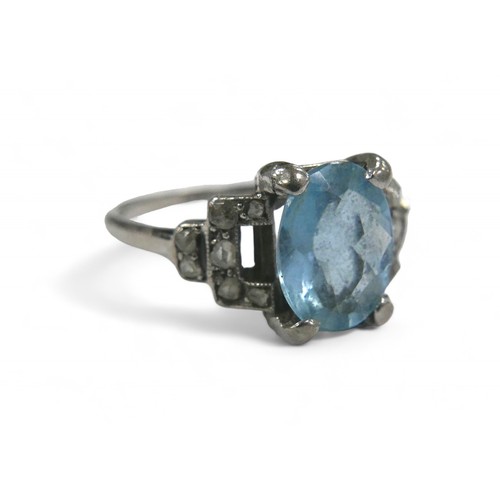 76 - Two dress rings, comprising a aquamarine style stone and diamond white gold ring, the oval cut pale ... 