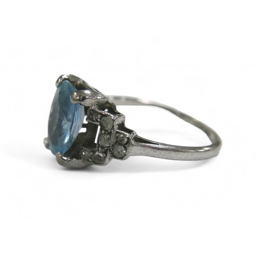 76 - Two dress rings, comprising a aquamarine style stone and diamond white gold ring, the oval cut pale ... 