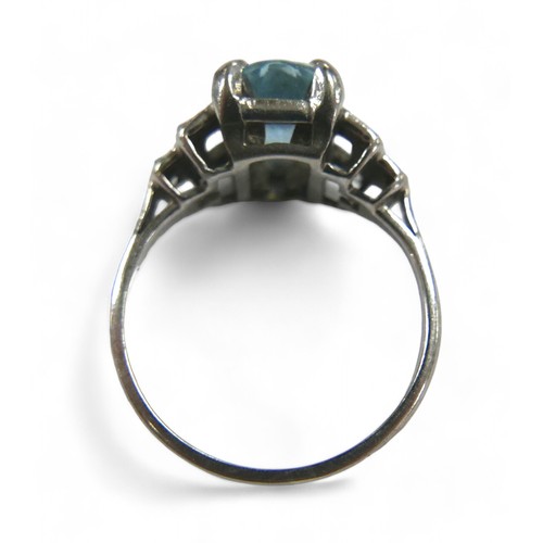 76 - Two dress rings, comprising a aquamarine style stone and diamond white gold ring, the oval cut pale ... 