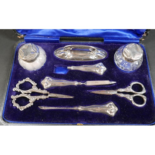 19 - A cased Edward VII silver part manicure set, Levi & Salaman, Birmingham 1906, together with a silver... 