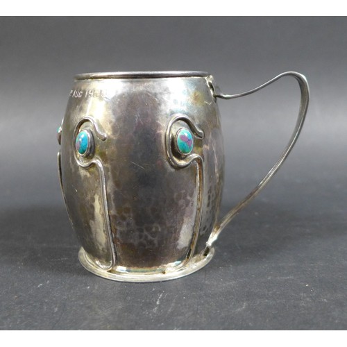 25 - An Art Nouveau silver and enamel tankard in the style of Liberty, with a hammered / plannished finis... 