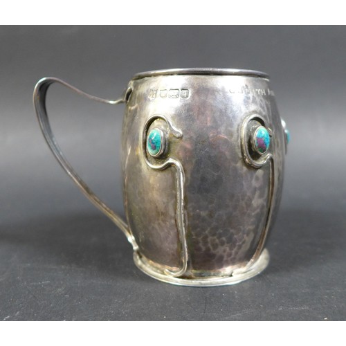 25 - An Art Nouveau silver and enamel tankard in the style of Liberty, with a hammered / plannished finis... 