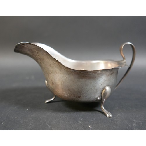 33 - Four items of silver, comprising a Georgian cream jug, a George V milk jug, an Edward VIII sauce boa... 