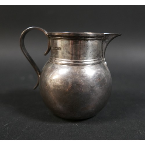 33 - Four items of silver, comprising a Georgian cream jug, a George V milk jug, an Edward VIII sauce boa... 