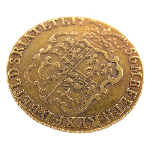 39 - A George III gold guinea, 1786, obverse with fourth laureate portrait of King George III right, reve... 