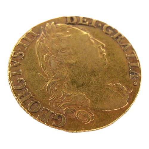 39 - A George III gold guinea, 1786, obverse with fourth laureate portrait of King George III right, reve... 