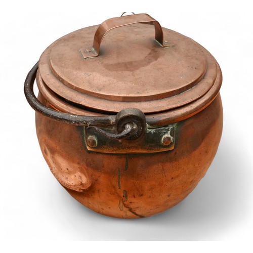 151 - A large copper and iron cook pot, a copper and iron lidded cook pot, an eastern copper tray and plan... 