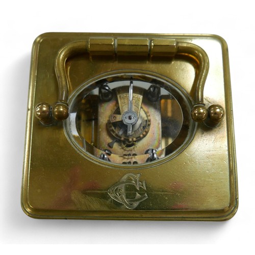 176 - A brass carriage clock, striking on a gong, 8 by 7 by 12cm high with handle down, with key and runni... 