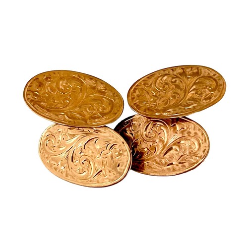 79 - A pair of Victorian 9ct yellow gold cufflinks, of oval form with chain links and engraved floral dec... 