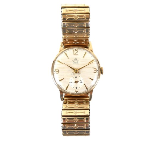 62 - A 9ct gold Smiths De Luxe gentleman's wristwatch, circa 1970, the textured silvered dial with Arabic... 