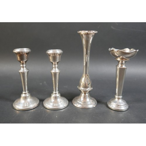 26 - A collection of silver items, comprising a pair of weighted candlesticks, 13cm high, two vases, larg... 