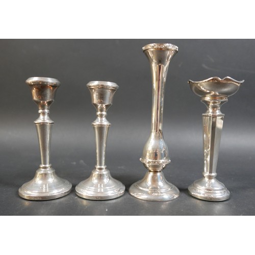 26 - A collection of silver items, comprising a pair of weighted candlesticks, 13cm high, two vases, larg... 