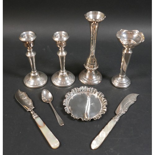 26 - A collection of silver items, comprising a pair of weighted candlesticks, 13cm high, two vases, larg... 