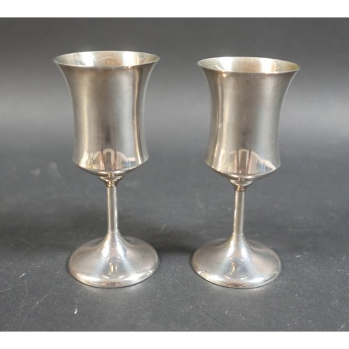 29 - A pair of contemporary silver goblets, with waisted bowls, plain stems and circular foot, A T Cannon... 