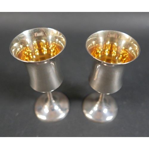 29 - A pair of contemporary silver goblets, with waisted bowls, plain stems and circular foot, A T Cannon... 