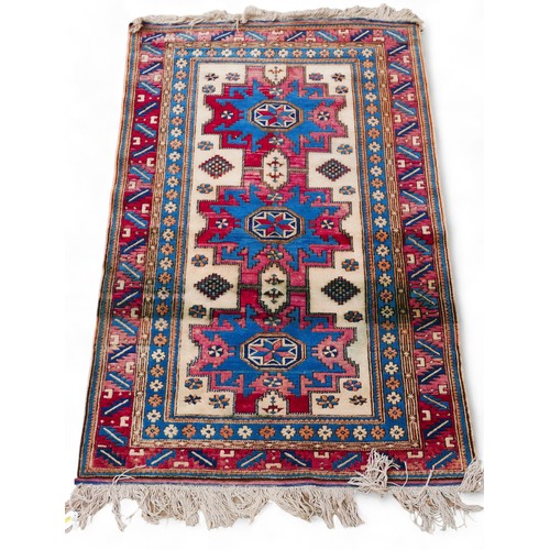 290 - A hand knotted Persian woolen rug with a cream field and geometric design,107 by 190cm.