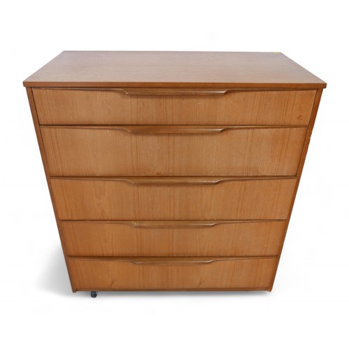 265 - A Mid Century teak chest of drawers, with bank of five drawers with carved, stylised handles, on cas... 