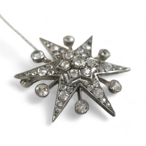 71 - A zircon and white metal starburst brooch, with safety chain,  4 by 3cm.