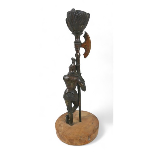 156 - A pair of Victorian bronze figural candlesticks, each modelled as a man in a suit of armour holding ... 