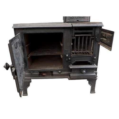 264 - A cast iron stove, 'The Holloway', with hot plates to the surface and two ovens, with flue, raised o... 