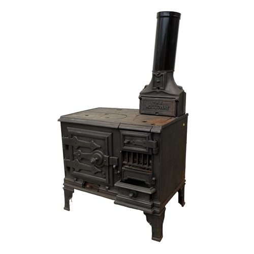 264 - A cast iron stove, 'The Holloway', with hot plates to the surface and two ovens, with flue, raised o... 