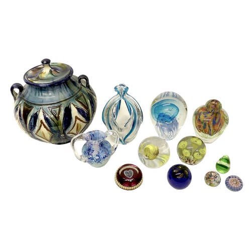 129 - A group of nine glass paperweights, various designs including canework, the largest a dump weight wi... 