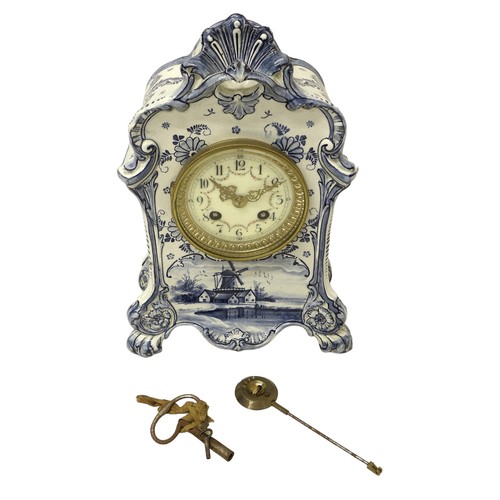 179 - An early 20th century Delft china mantel clock, with 8 day barrel movement striking on a bell, the c... 