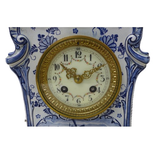 179 - An early 20th century Delft china mantel clock, with 8 day barrel movement striking on a bell, the c... 