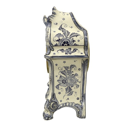 179 - An early 20th century Delft china mantel clock, with 8 day barrel movement striking on a bell, the c... 