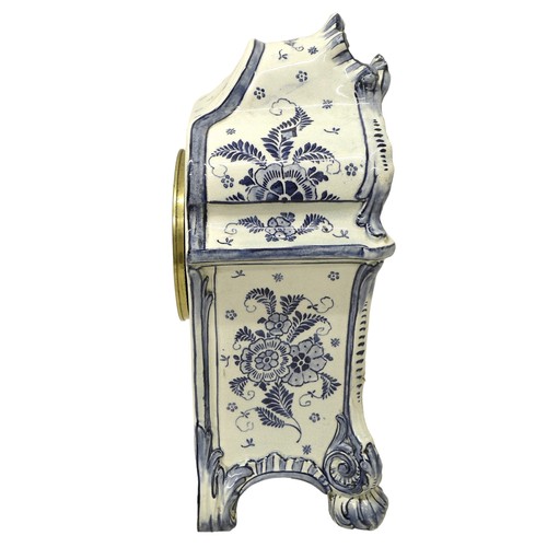 179 - An early 20th century Delft china mantel clock, with 8 day barrel movement striking on a bell, the c... 