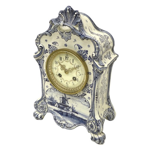 179 - An early 20th century Delft china mantel clock, with 8 day barrel movement striking on a bell, the c... 