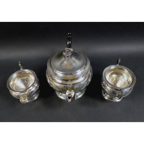 4 - A George V silver three piece tea service, comprising teapot on circular foot, with ebonized handle,... 