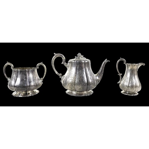 35 - A Victorian three piece tea set, of bombe shape with engraved decoration, the teapot with acorn fini... 