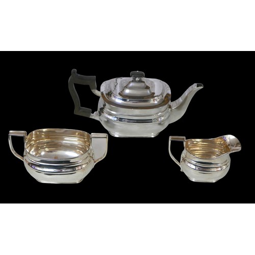 6 - A George V three-piece silver tea set, comprising teapot, 28 by 12 by 13cm high, twin handled sugar ... 