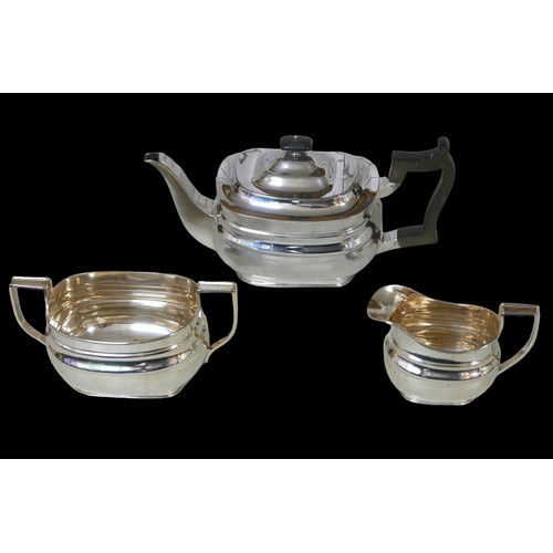 6 - A George V three-piece silver tea set, comprising teapot, 28 by 12 by 13cm high, twin handled sugar ... 