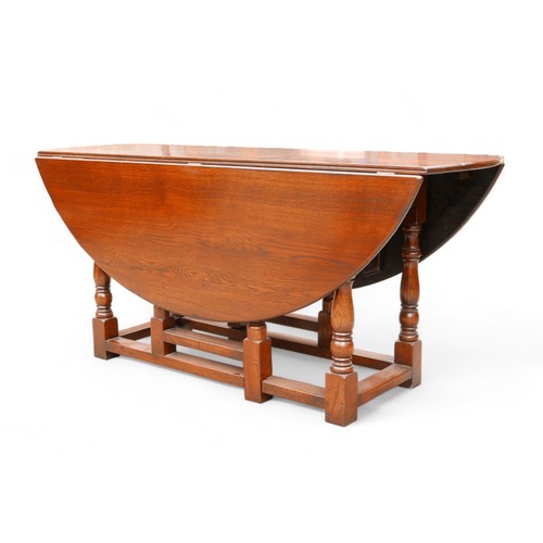 343 - An 18th century style oak drop leaf dining table, 167 by 148 extended by 76cm high.