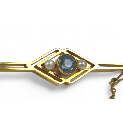 25 - A 15ct gold brooch, 55mm, together with two jade pendants, one with a 9ct mount, 3.6g. (3)