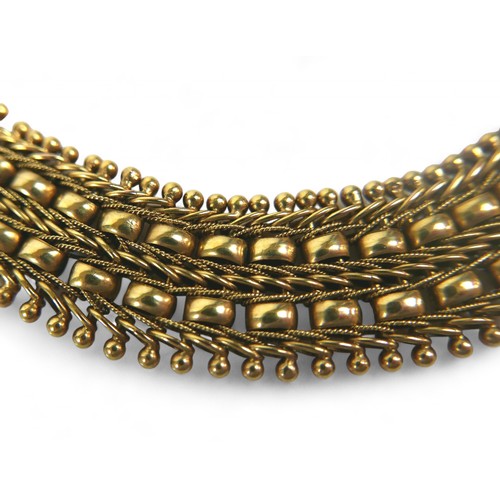 4 - A gold fancy link bracelet, tests to approximately 18ct, 16mm wide, 22.6g.