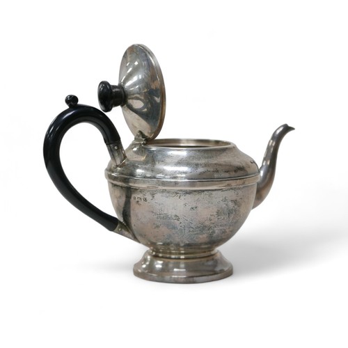 83 - A George V and later silver bachelor's associated three-piece tea service, comprising a teapot with ... 