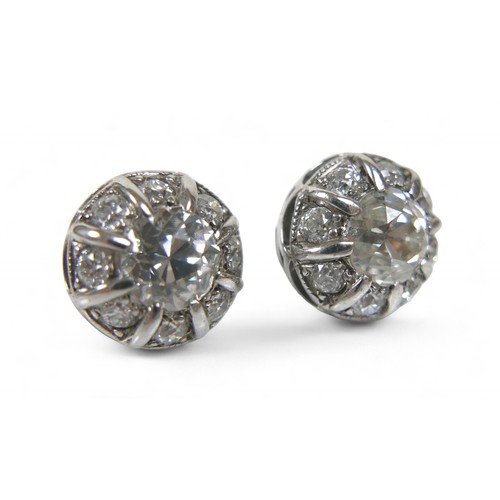 55 - A pair of diamond and 18ct white gold earrings, central stones approximately 6.5mm, both surrounded ... 