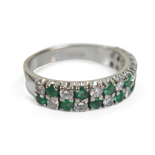 36 - An 18ct white gold emerald, diamond and sapphire ring, with twenty-eight, round cut stones, each 2mm... 