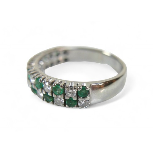 36 - An 18ct white gold emerald, diamond and sapphire ring, with twenty-eight, round cut stones, each 2mm... 