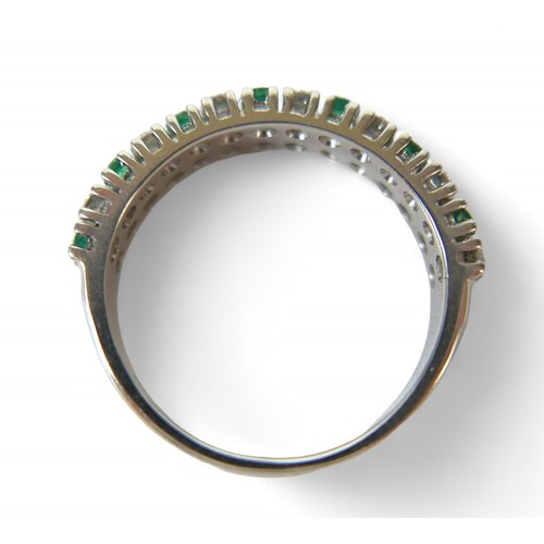 36 - An 18ct white gold emerald, diamond and sapphire ring, with twenty-eight, round cut stones, each 2mm... 