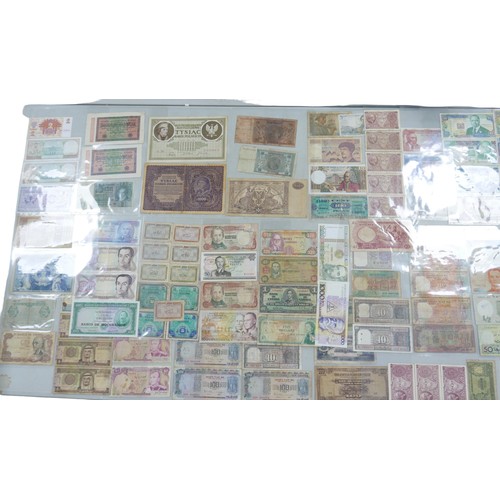 112 - A large collection of world bank notes, in an album and three folders.